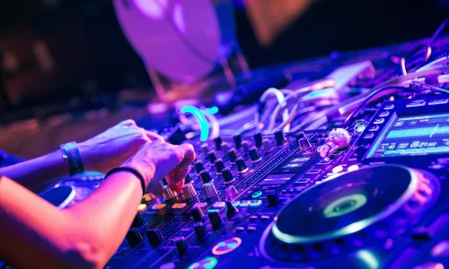 Wedding DJ in Mallorca mixing music during an outdoor beach ceremony at sunset